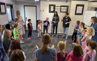 Elementary students participating in a group activity during summer music camp at Lott Music Studio in Ames, IA.