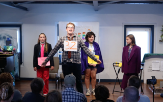Middle school students performing a musical theater scene on stage during Lott Music Studio summer camp.