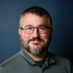 Professional headshot of Brandon Williams, guitar, bass, and ukulele instructor at Lott Music Studio.